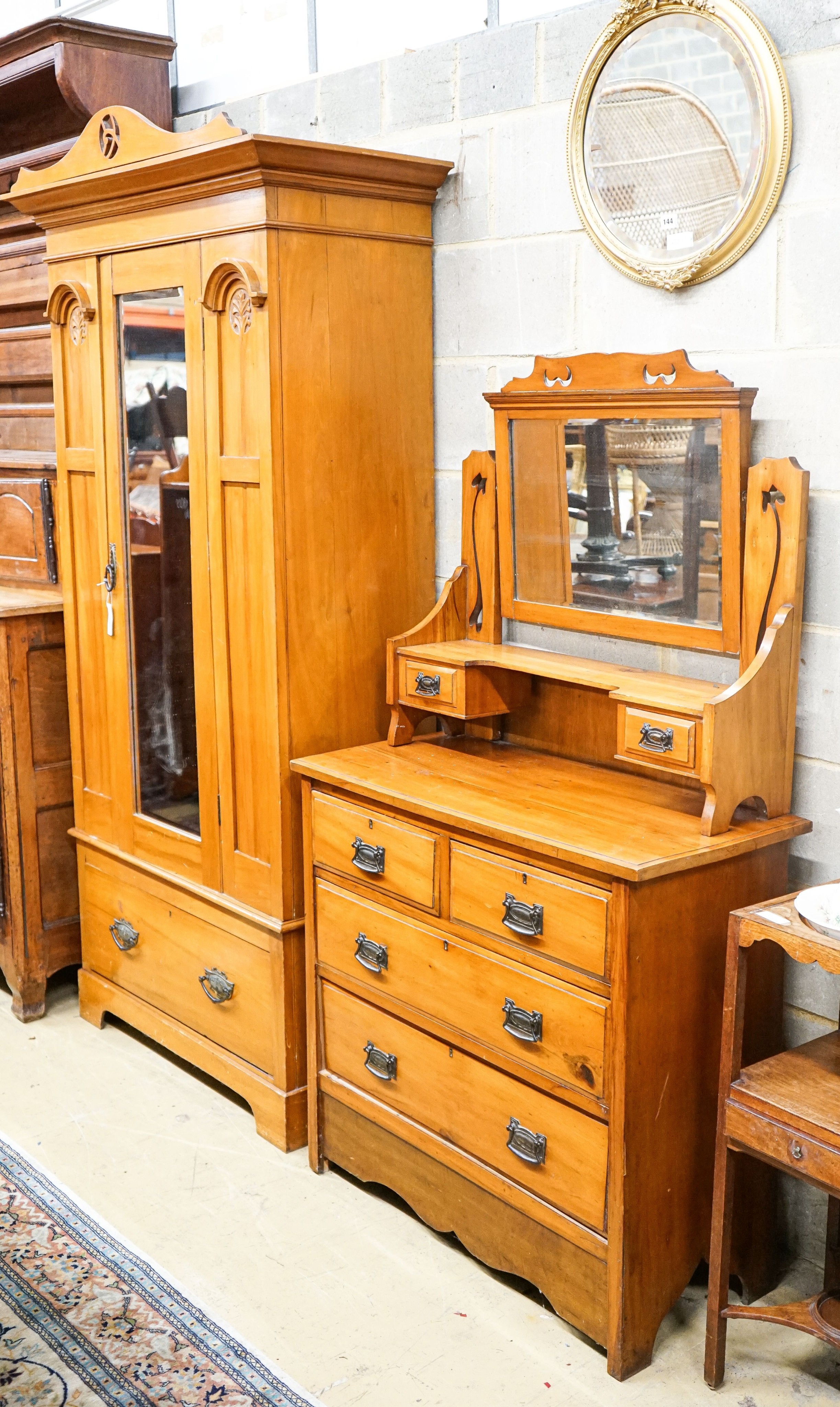 A late Victorian satin walnut mirrored wardrobe, length 105cm, depth 48cm, height 210cm and a dressing table